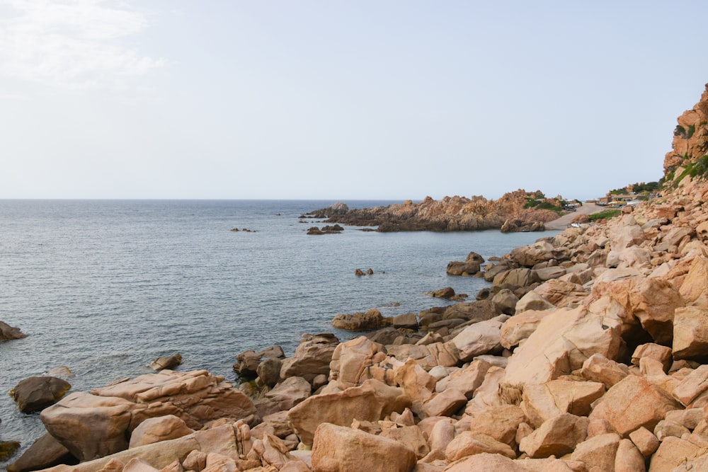 a rocky shore line with a body of water