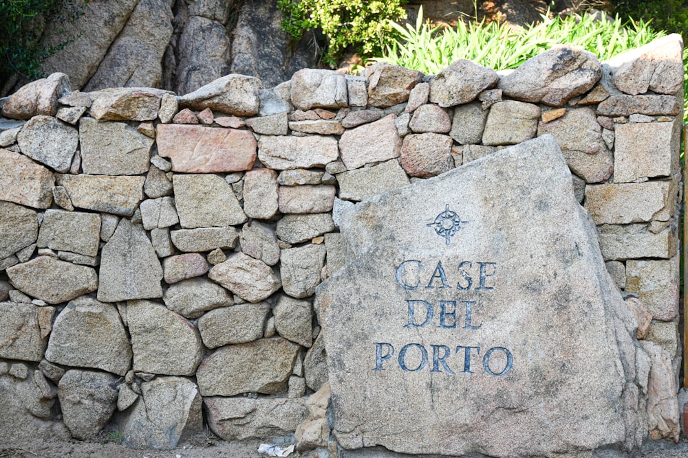 a stone wall with a sign on it