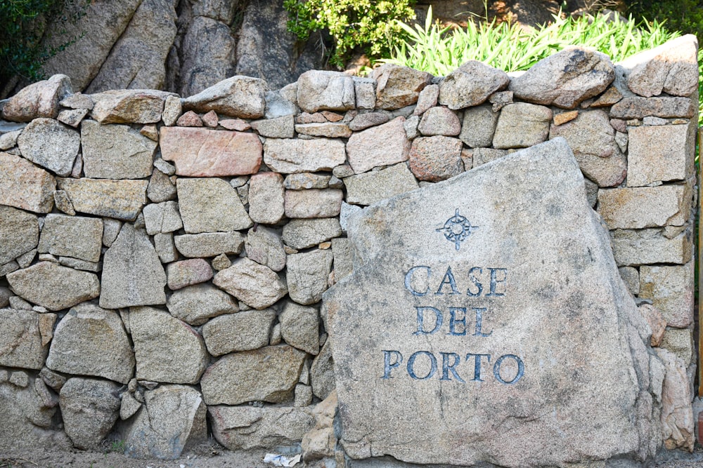 uma parede de pedra com uma placa