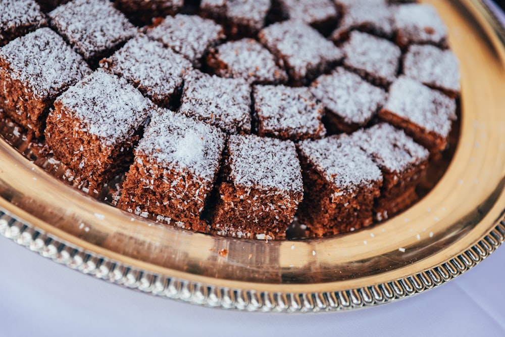 a platter of brownies covered in powdered sugar