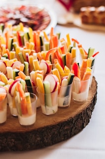 Neatly arranged colorful vegetable sticks with a healthy dip on the side