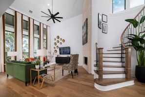 a living room filled with furniture and a staircase