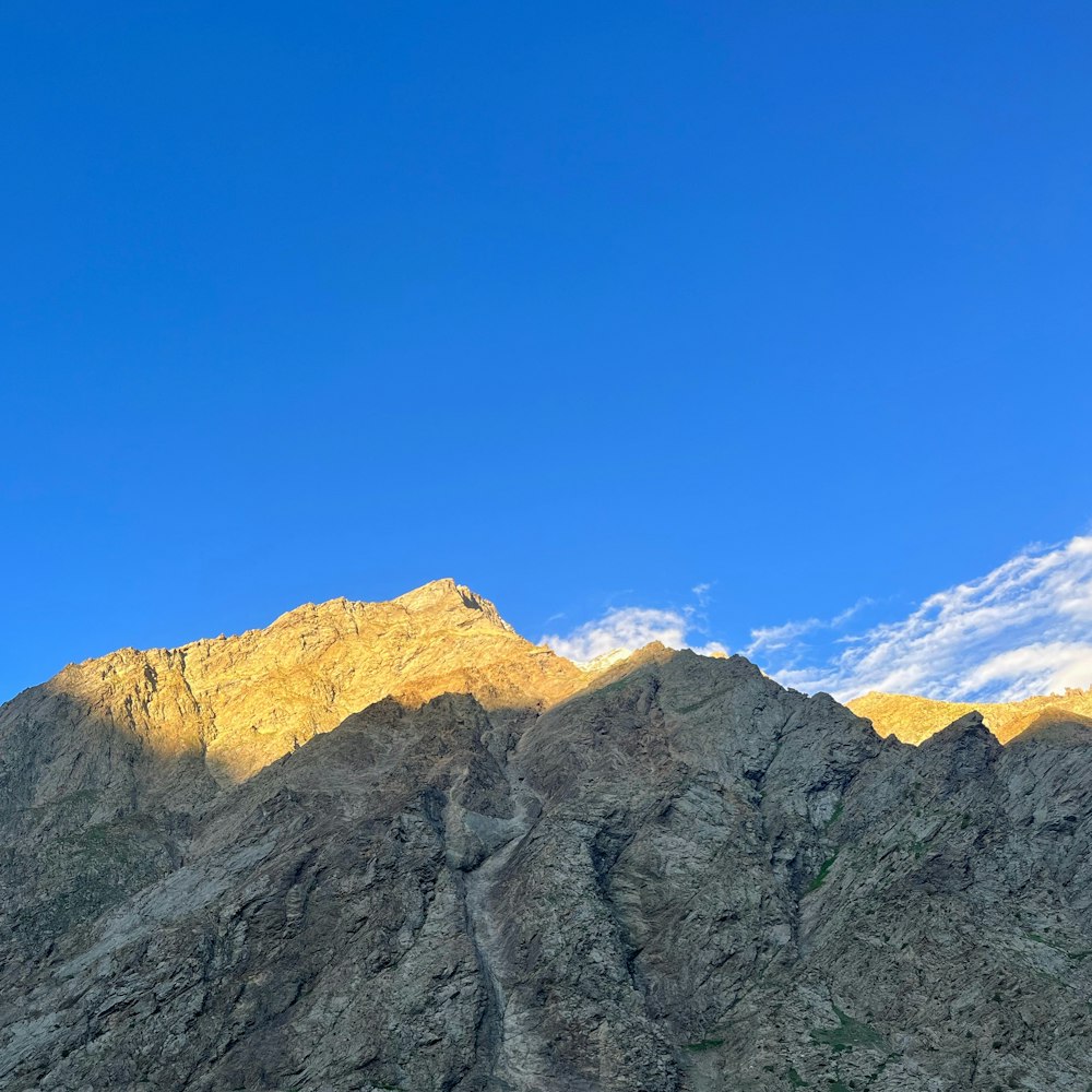 a view of a mountain range with a blue sky in the background