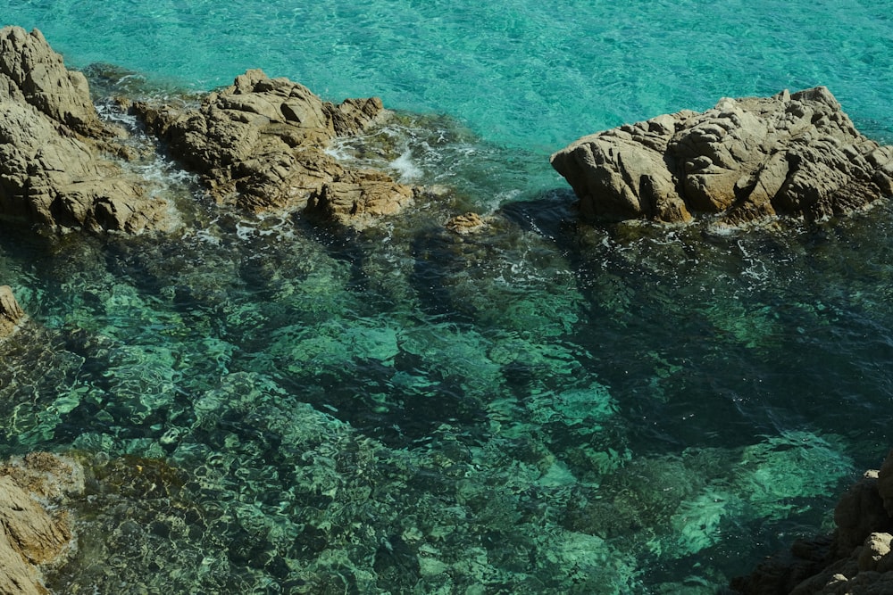 a couple of rocks that are in the water