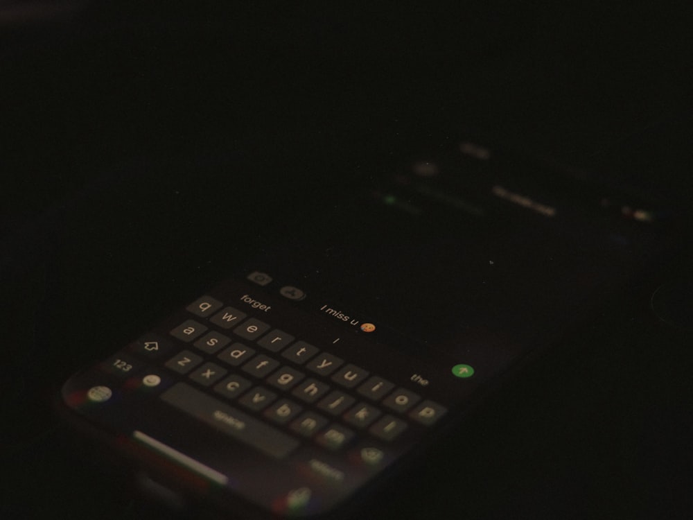 a close up of a cell phone in the dark