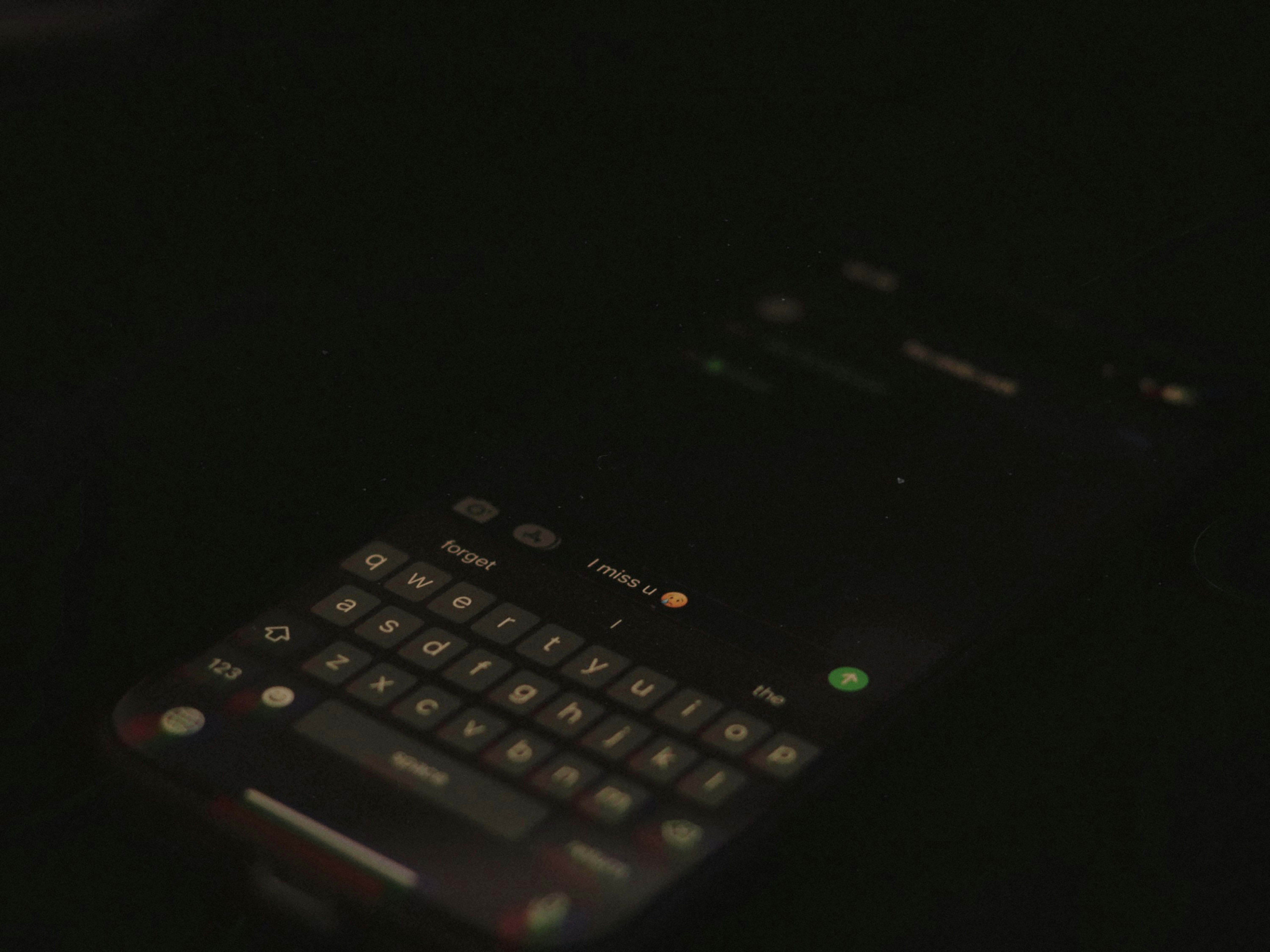 close up of fingers typing letter tiles on a modern smartphone screen