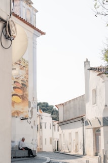 A quiet village street in the Luberon, where one of the artworks is displayed outdoors.