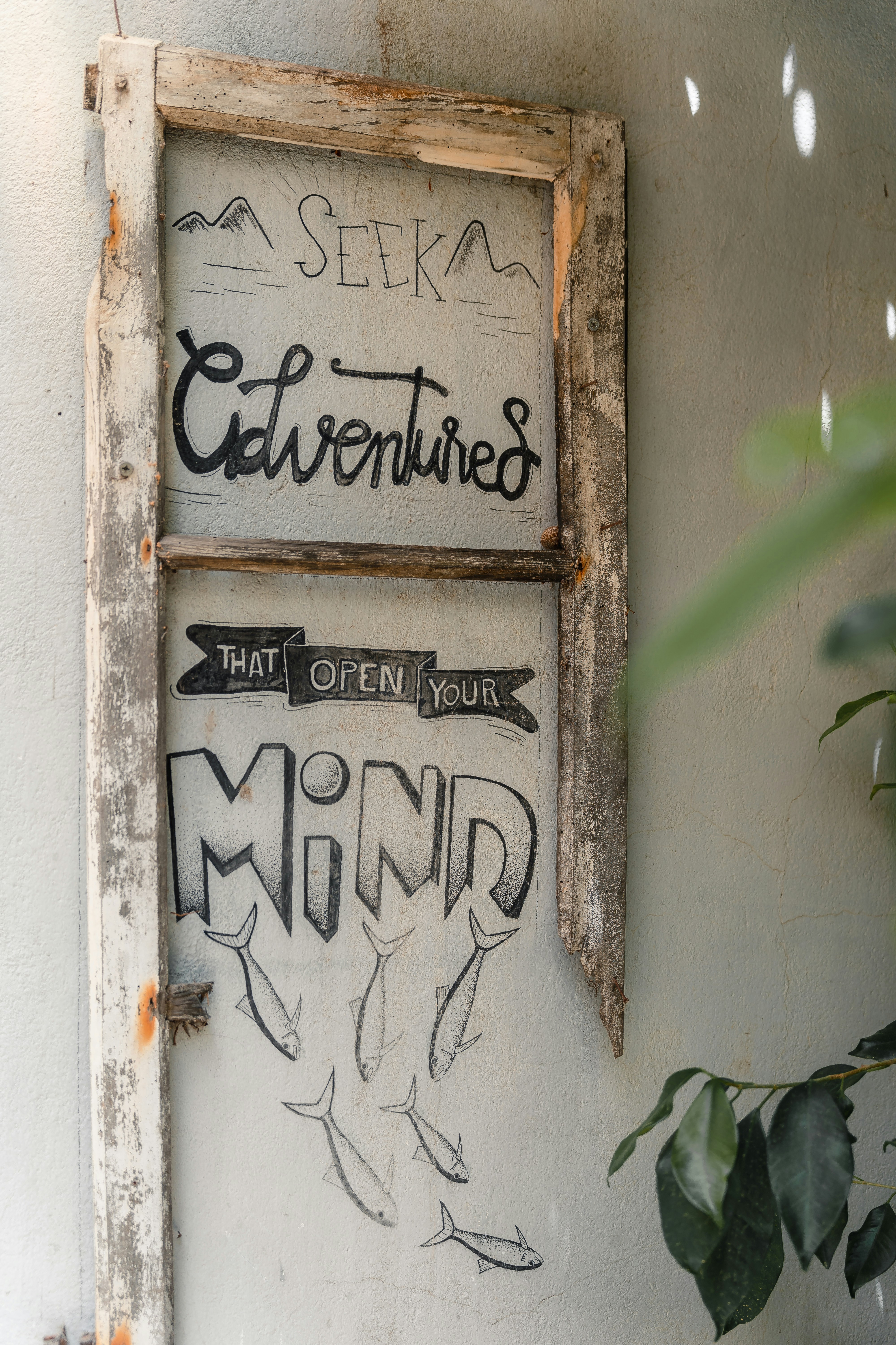 a sign on a wall with graffiti on it