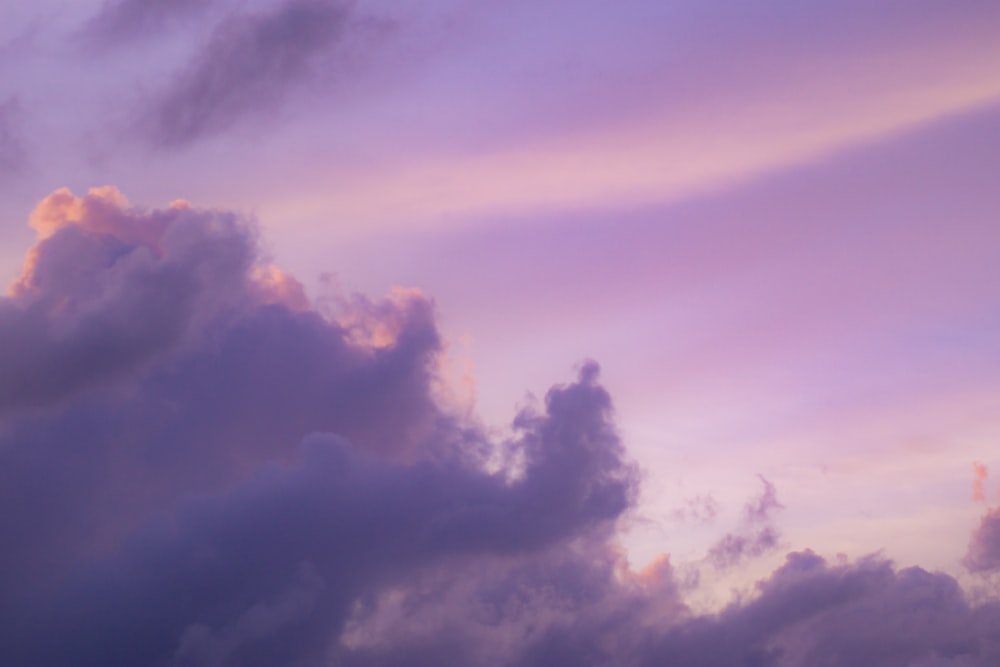 a plane flying in the sky with a lot of clouds