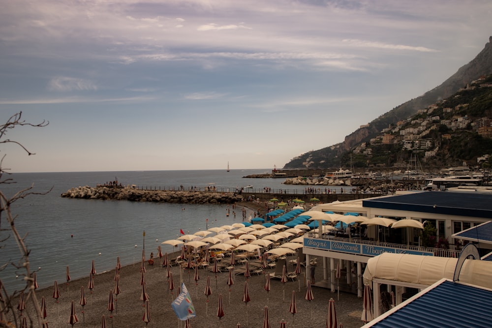 a beach with many umbrellas and chairs on it