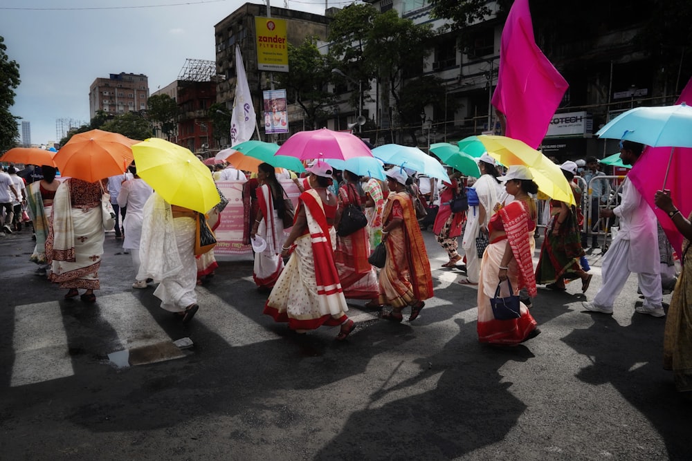 a group of people walking down a street holding umbrellas