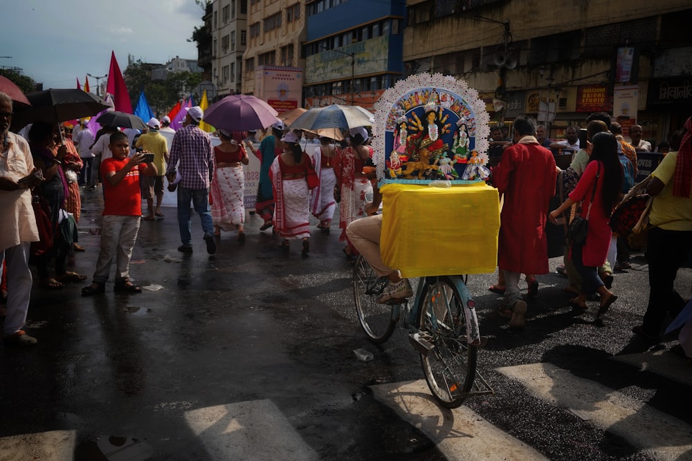 a group of people walking down a street holding umbrellas