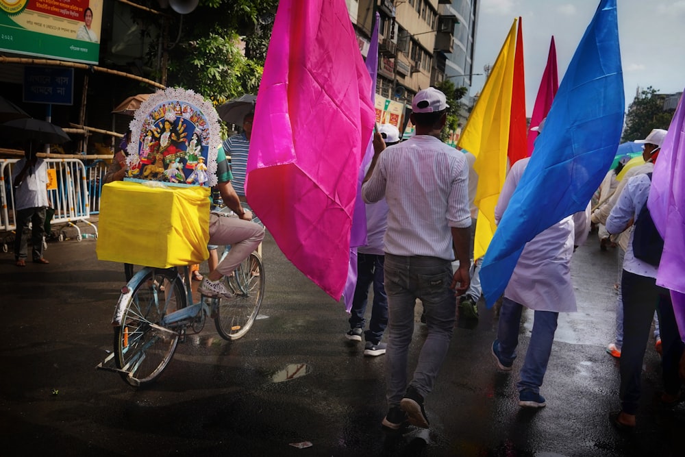 a group of people walking down a street holding umbrellas