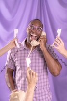 a man talking on a phone while holding a phone to his ear