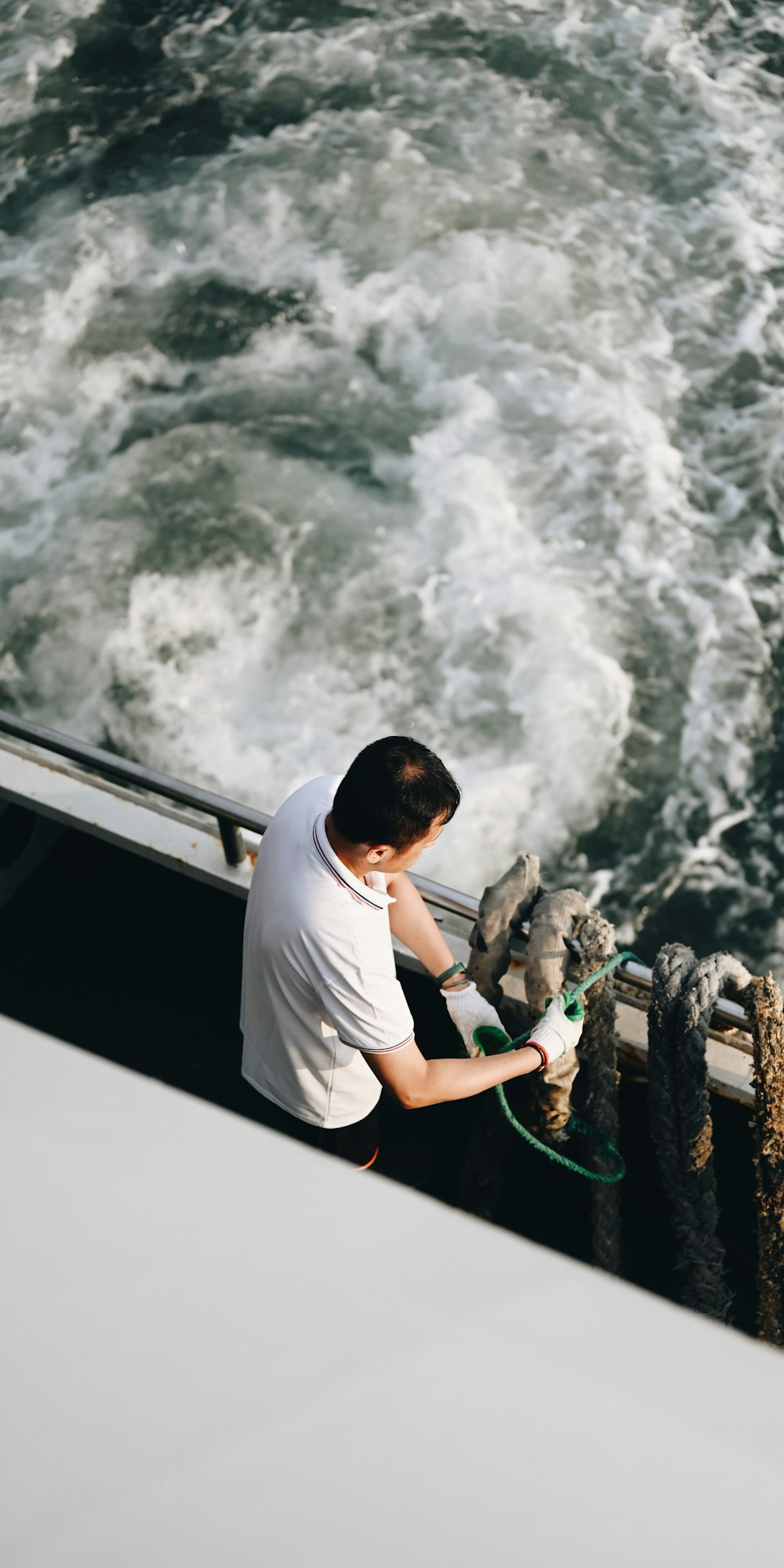 a man is washing his hands on the railing of a boat