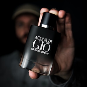 A customer’s hand delicately holding an Armada Parfumo bottle, highlighting the brand’s refined design.