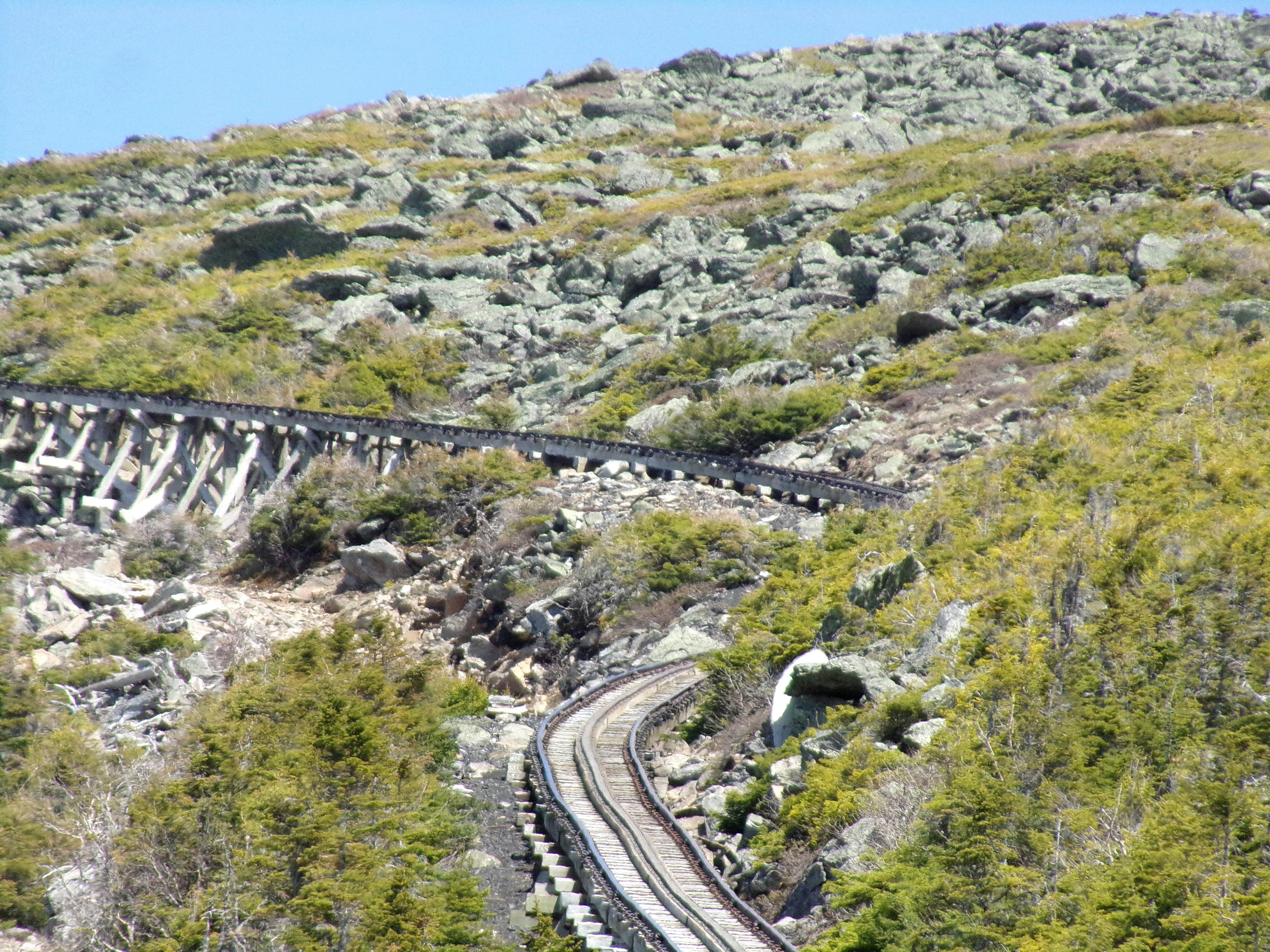 Steep rack railway ascending dramatic rock faces of Pilatus mountain above clouds