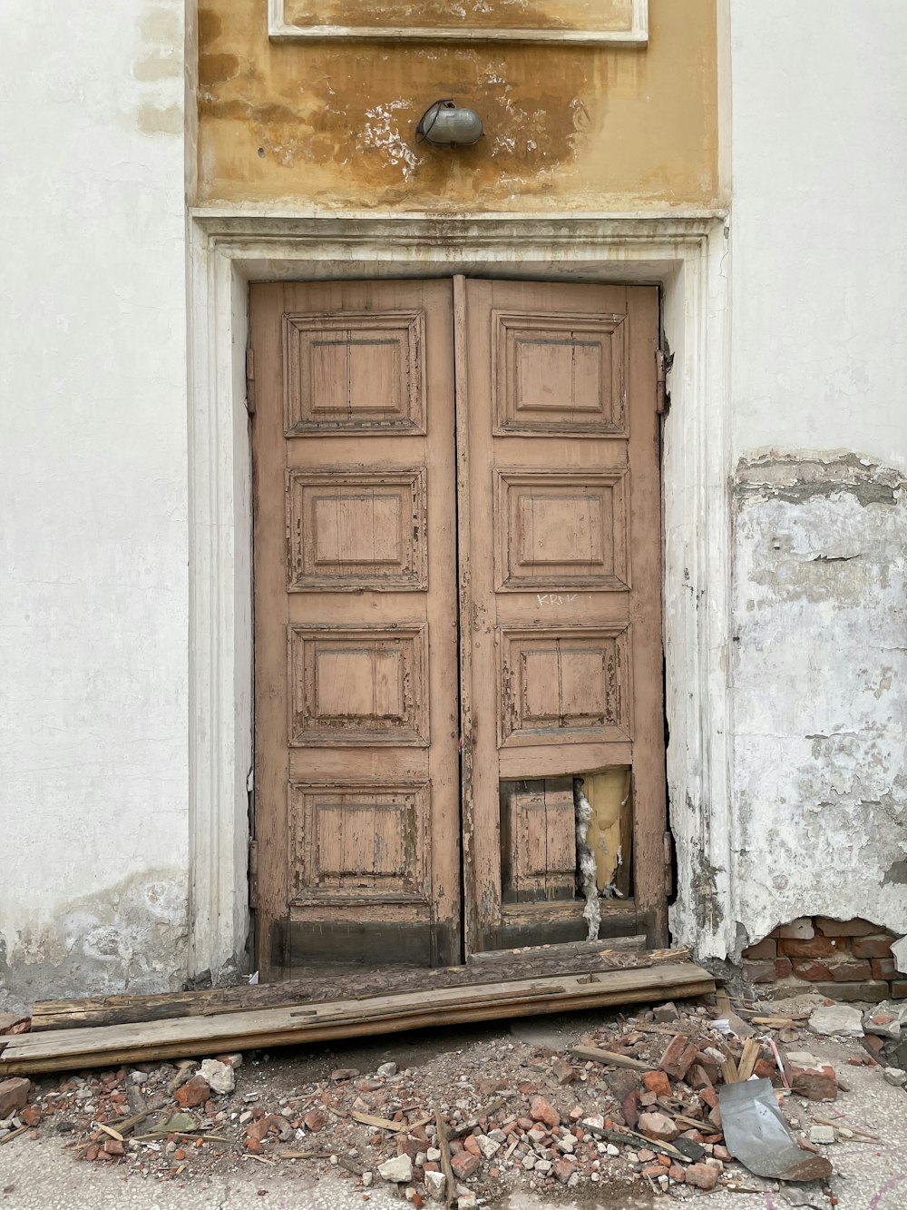 an old wooden door with a sign above it