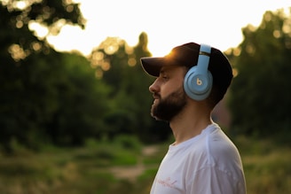 a man wearing headphones standing in a field
