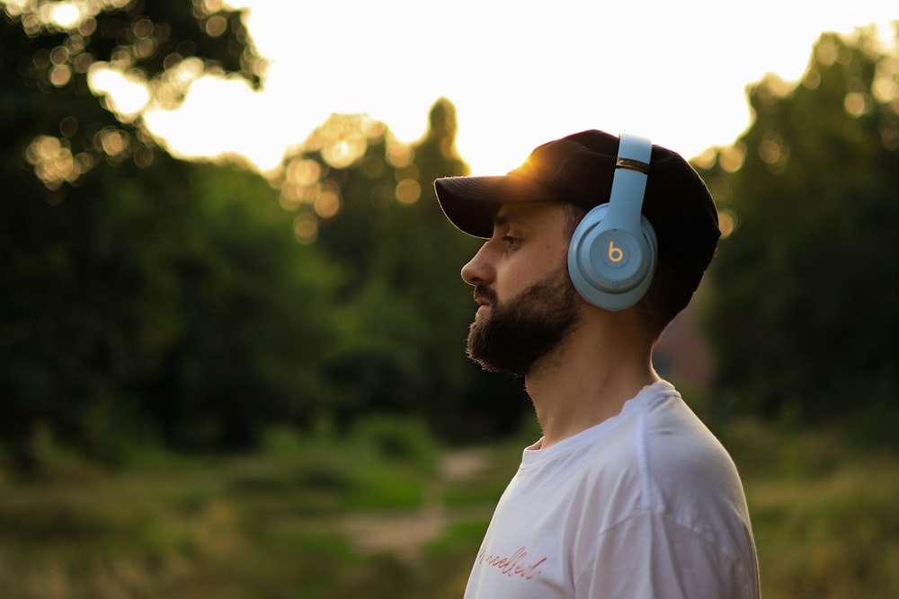 a man wearing headphones standing in a field