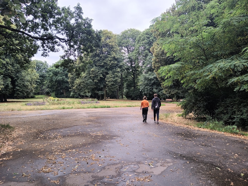 a couple of people walking down a road