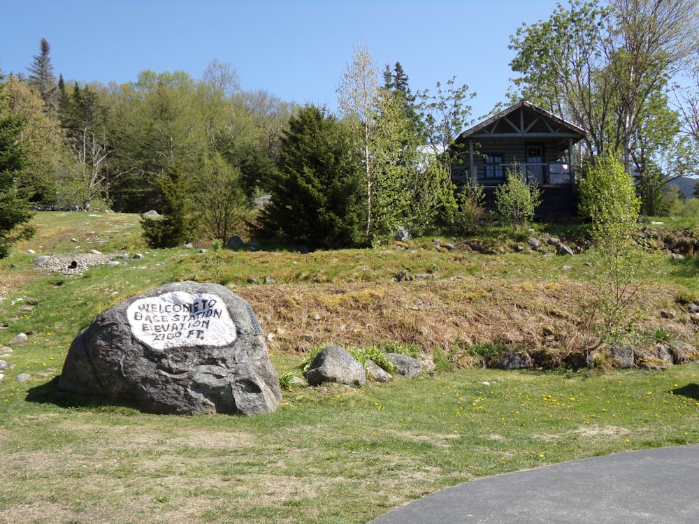 a large rock sitting in the middle of a field