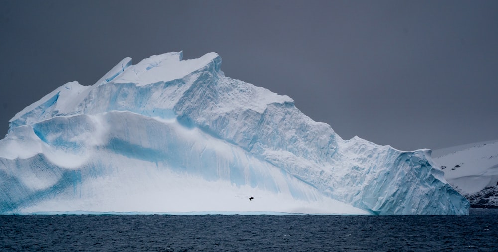 a large iceberg in the middle of a body of water