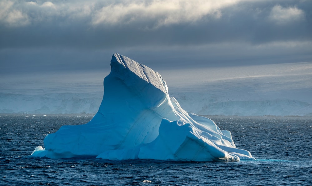 a large iceberg floating in the middle of the ocean