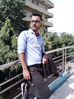 A stylish quarter zip layered over a collared shirt, captured in soft afternoon light on a rooftop.