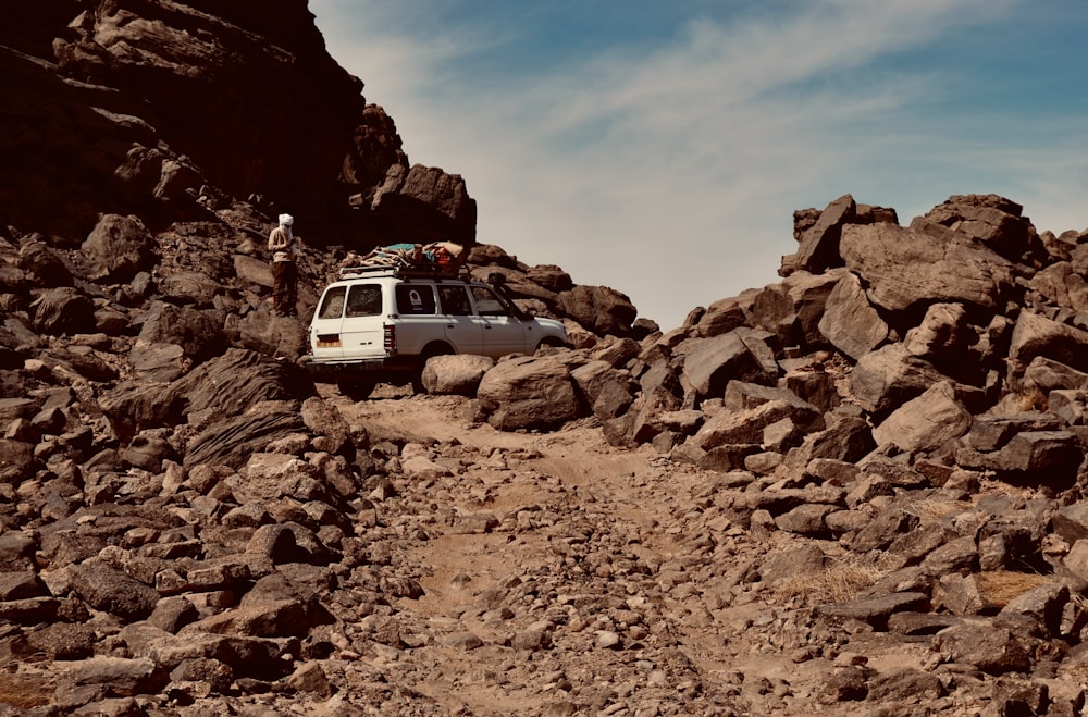 a van is parked on a rocky trail