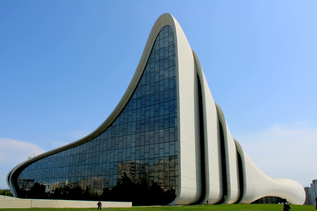 a very tall building with a very long curved roof, Baku Azerbaijan
