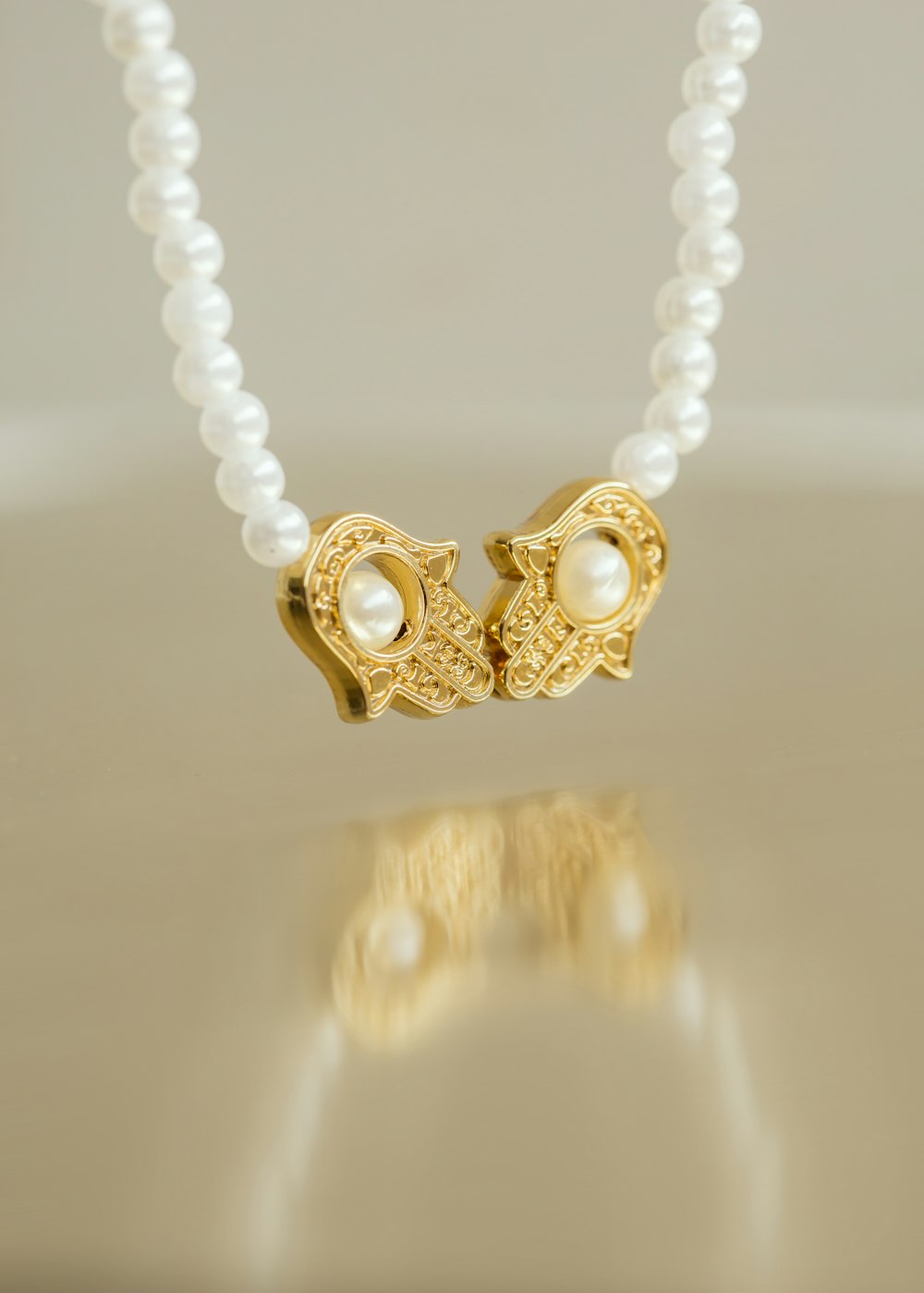 a necklace with pearls and a gold clasp