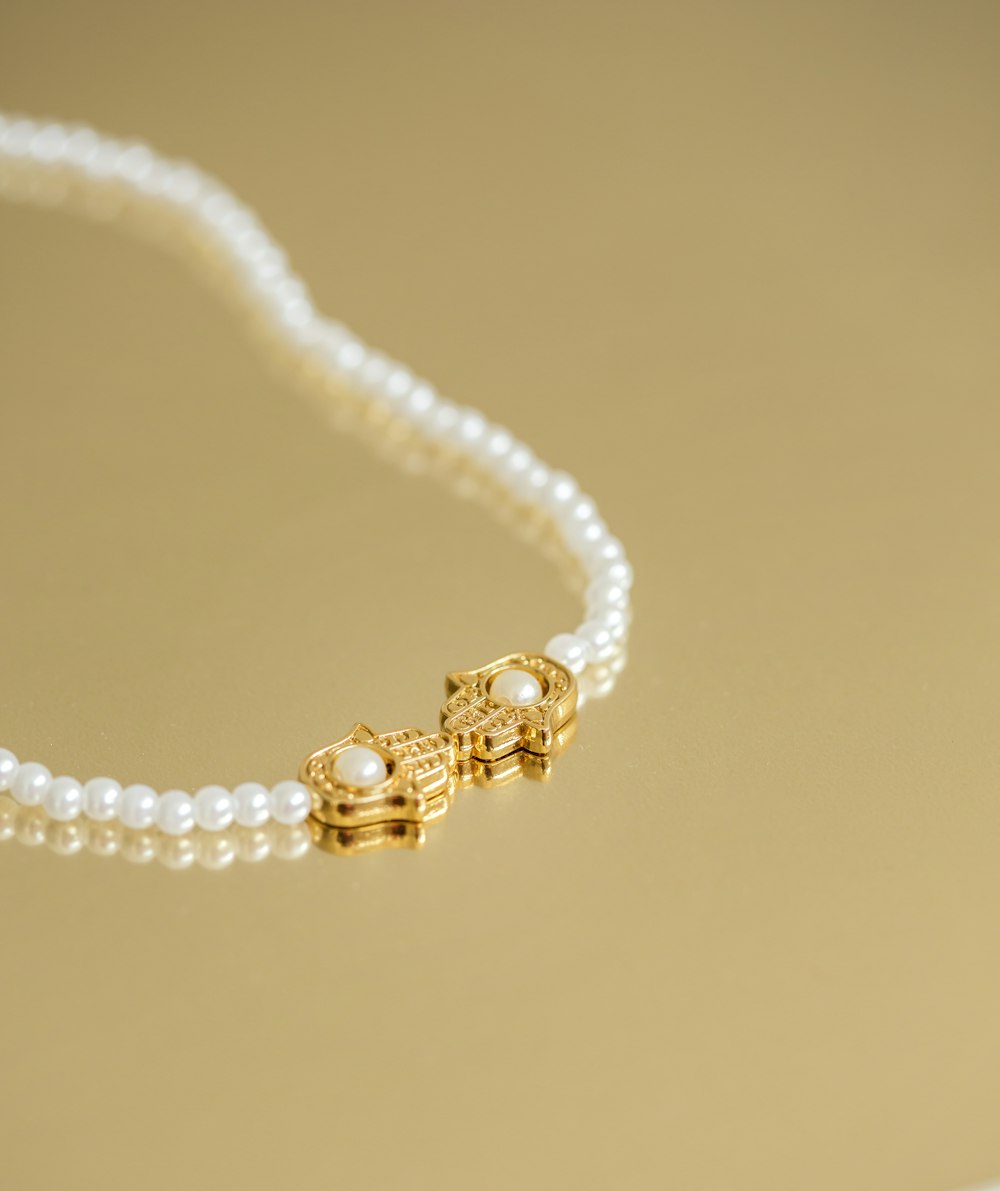 a necklace with pearls and a gold clasp