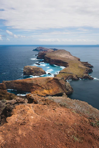 a view of the ocean from the top of a hill