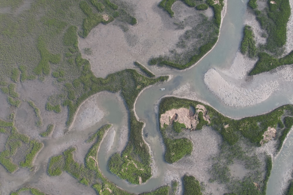 an aerial view of a river and land