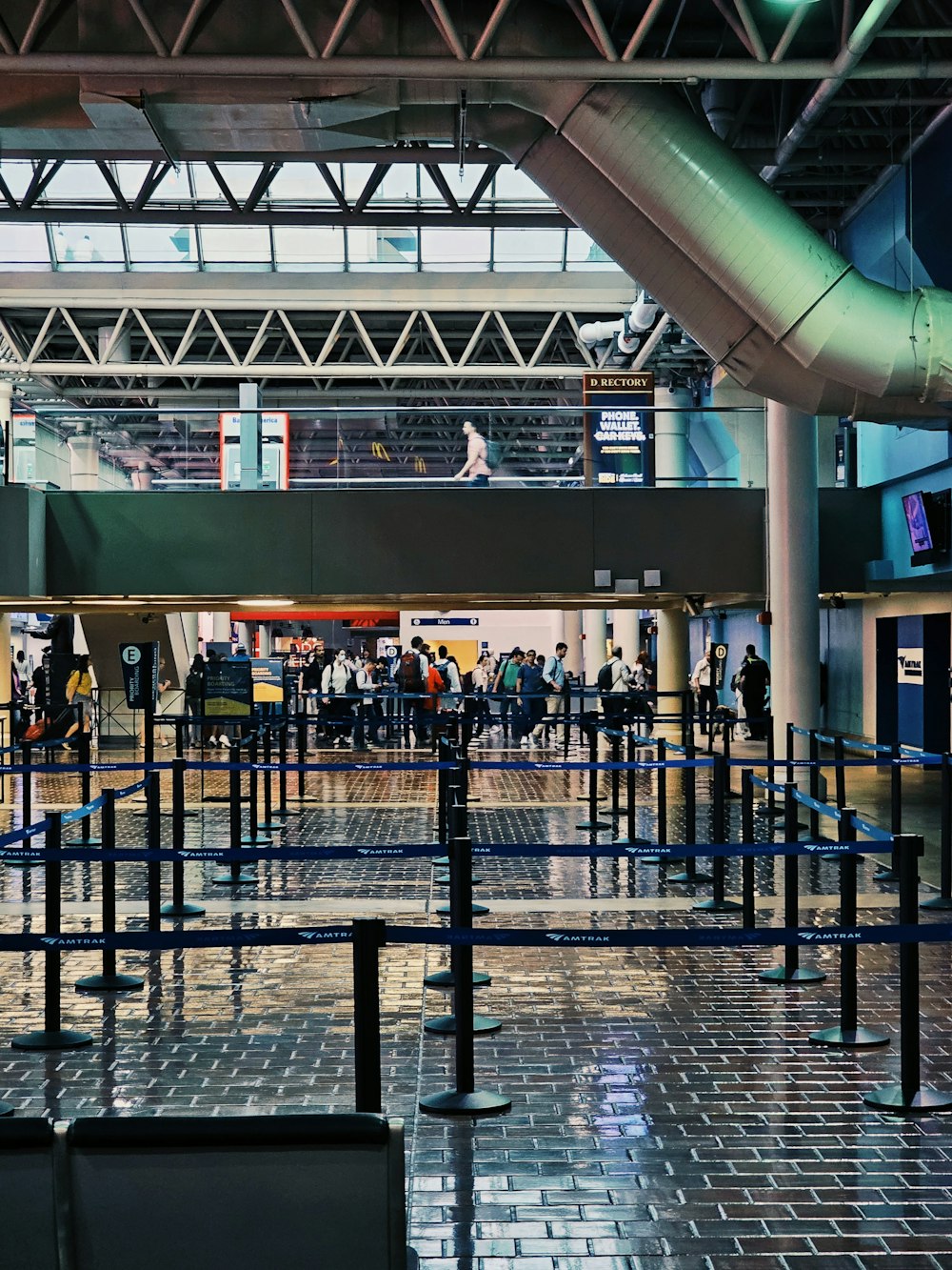 a group of people standing around in an airport