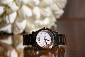 An elegant black Invicta watch placed on a sophisticated background.