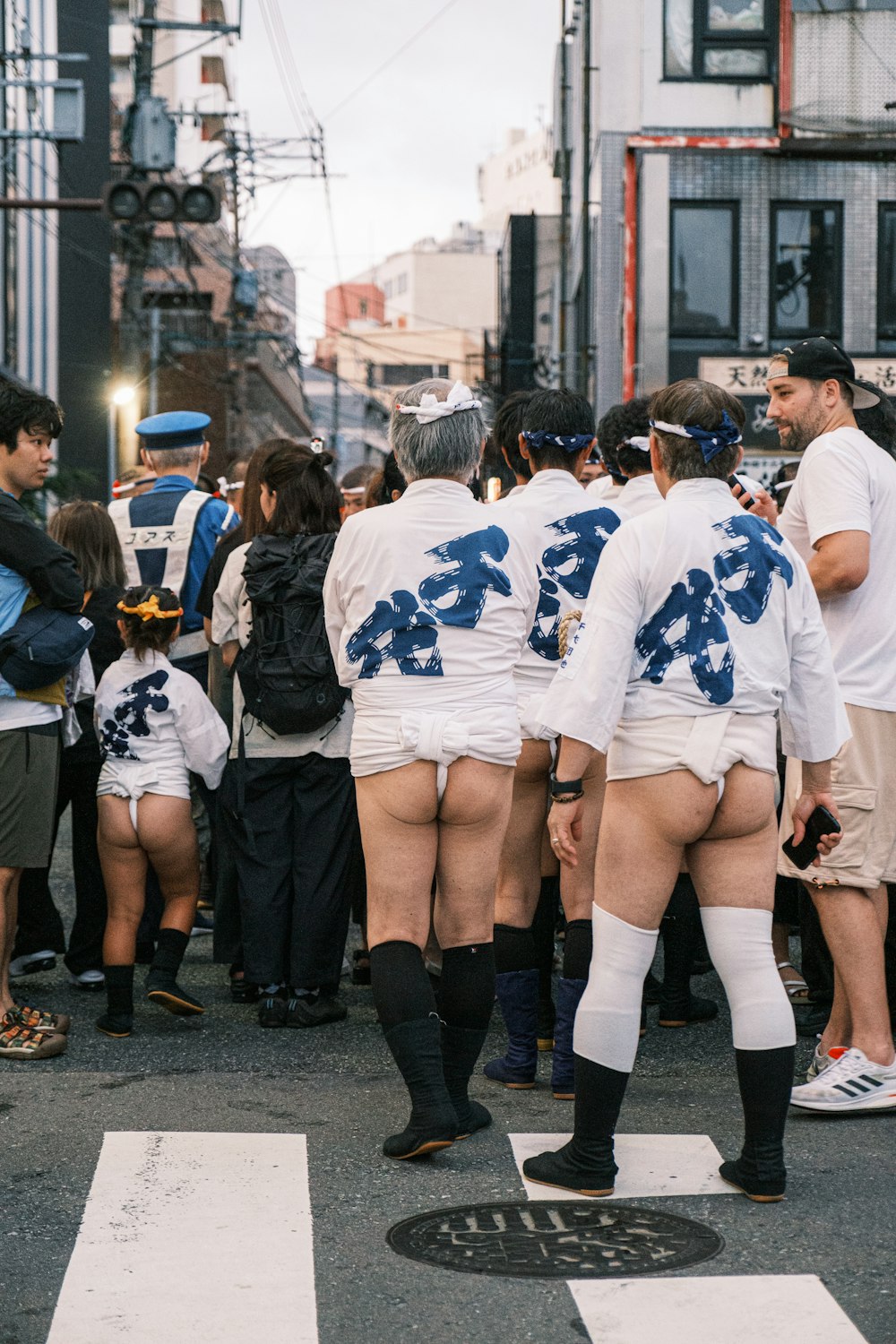 a group of people standing in the middle of a street