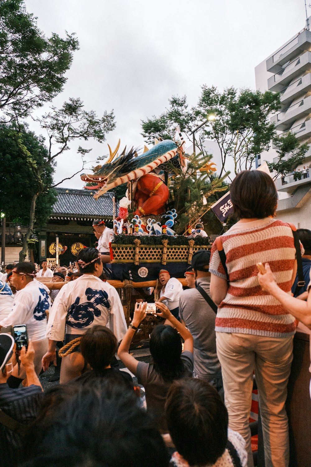 a crowd of people standing around a float