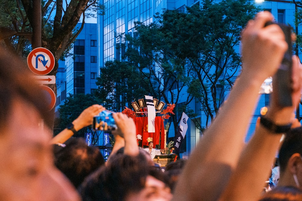 a crowd of people holding up their cell phones