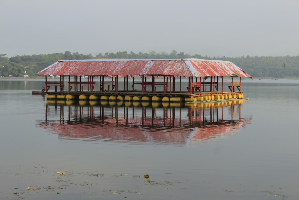 a red and white building sitting on top of a body of water