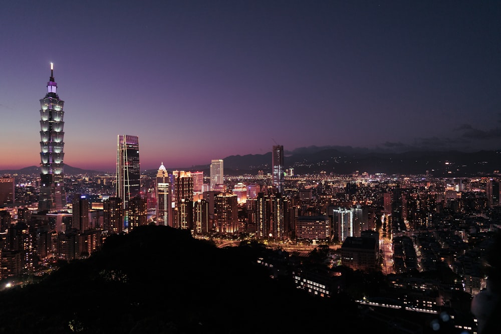 a view of a city at night from the top of a hill