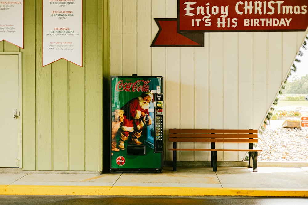 a vending machine sitting next to a wooden bench