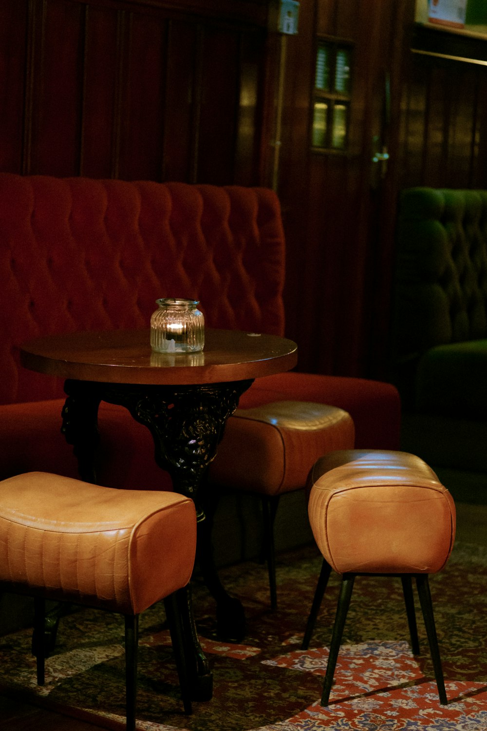 a small table with two stools in a room