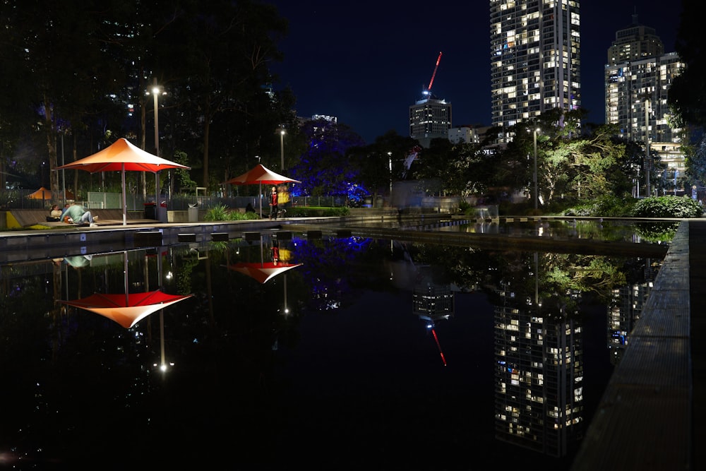 a city at night with lights reflecting in the water