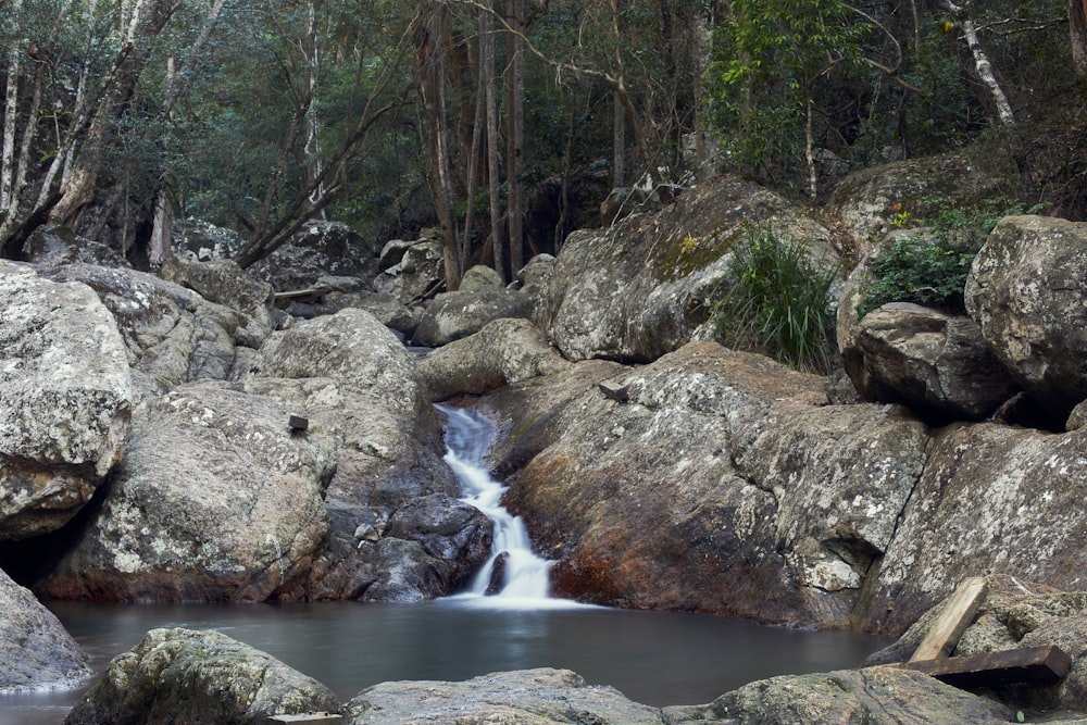 a small waterfall in the middle of some rocks