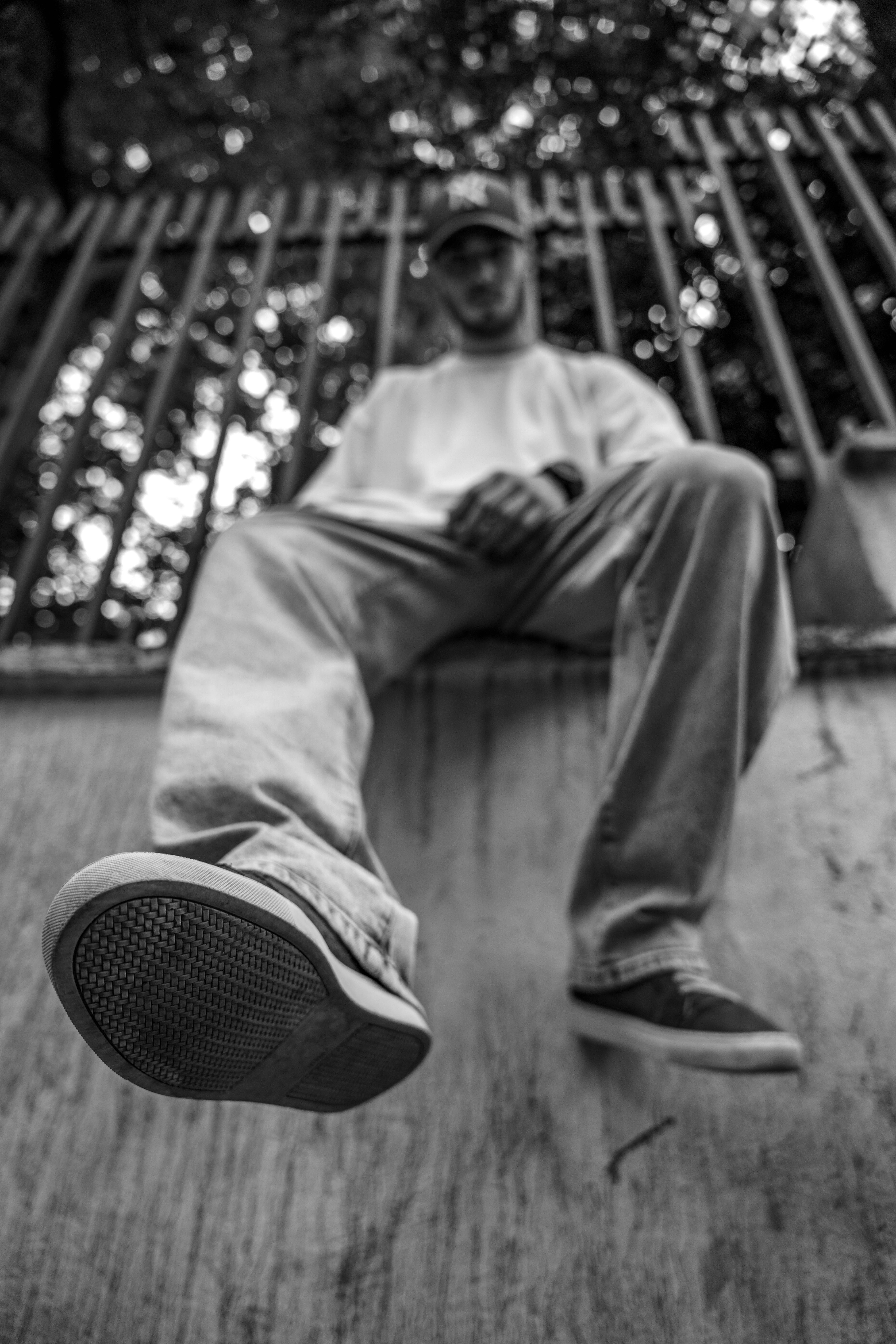 a black and white photo of a man sitting on the ground