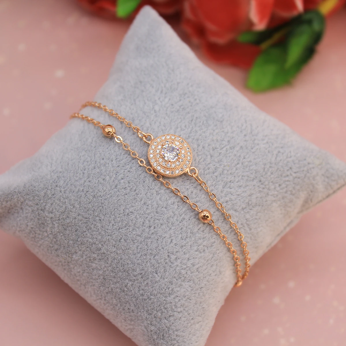 Diamond bangle bracelet styled on a pillow with a rose