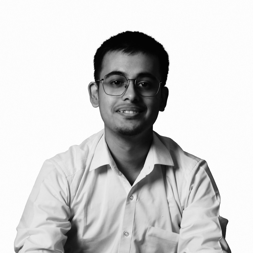 a black and white photo of a man wearing glasses