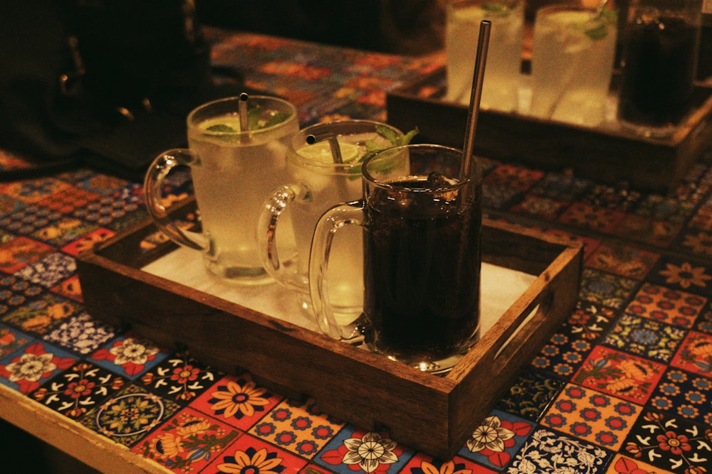 a tray with two mugs of drinks on a table